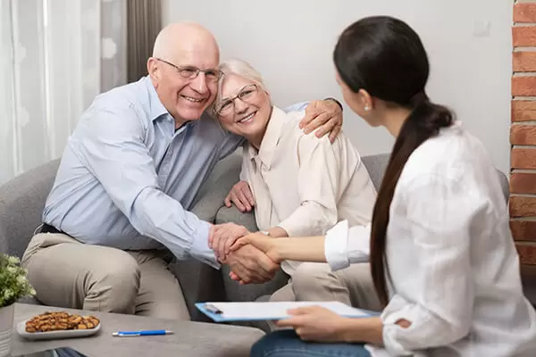 senior couple speaking with a hearing professional