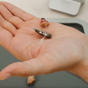 doctor holding hearing aid